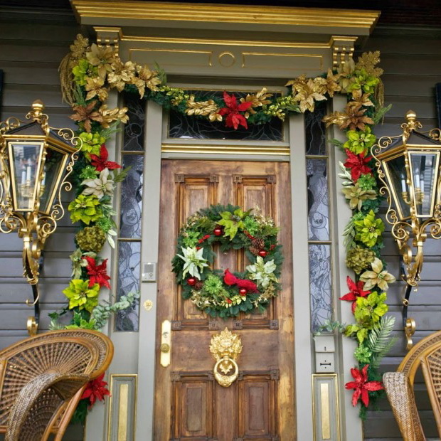 Remarkable Front Porch Decorating For Christmas By Colorful Flowers Around The Door Also Between Golden Wall Lamps Completed With Green Circle On The Brown Wooden Door