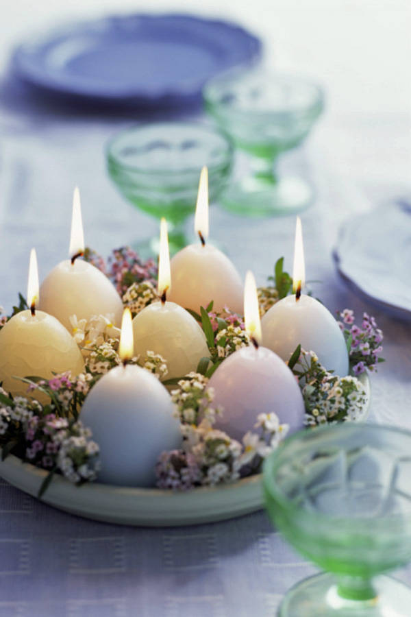 Egg-shaped candles on table