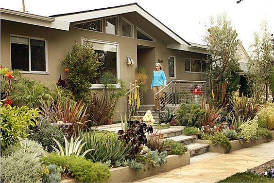 Los Angeles, CA - May 11, 2009: Randy Bergman walks out the front of her home in the Cheviot Hills neighborhood of Los Angeles. Bergman's front yard is very drought tolerant with a colorful assortment of hip unusual-looking succulents. The backyard is meant to include reminders of New York where Bergman lived before and includes a patio shade modeled after NYC street grates.  (Al Seib / Los Angeles Times)